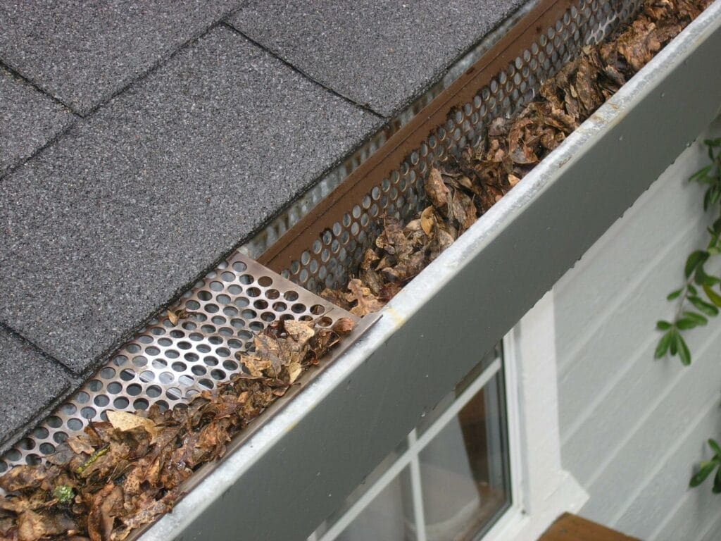 Gutter Cleaning; Accumulated Dirt and Roofing Granules Gutter Cleaning; Accumulated Dirt and Roofing Granules